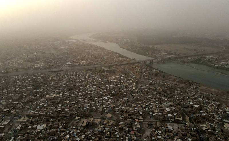 An aerial view of the Tigris river and the western side of Iraq's northern city of Mosul during a dust storm, June 21, 2022. AFP