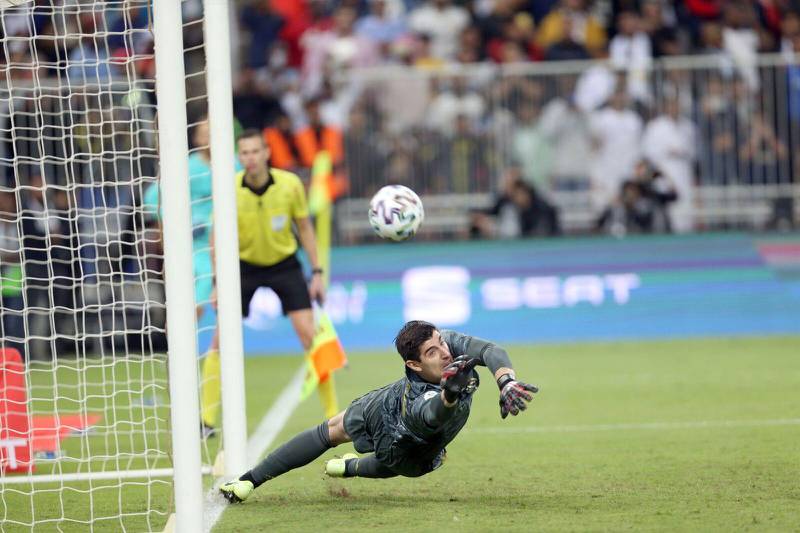 Real Madrid goalkeeper Thibaut Courtois saves a penalty during the shootout. EPA
