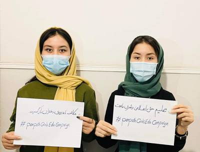 Campaigners hold placards to raise awareness of girls' education rights in Afghanistan.