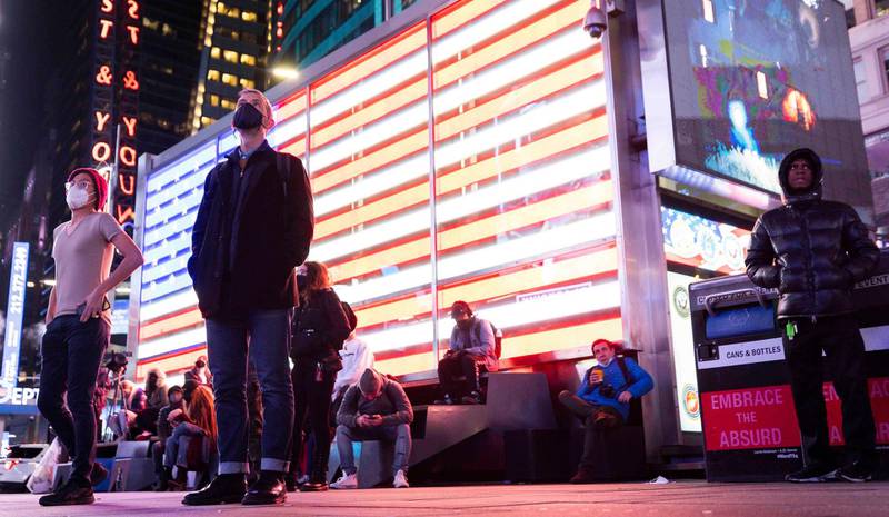 People gather to watch results in the presidential election on a screen in Times Square in New York, New York.  EPA