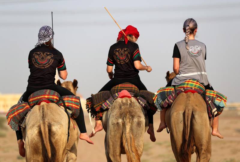 Linda Krockenberger, centre, leads a training session for women at the  Arabian Desert Camel Riding Centre near Dubai. EPA