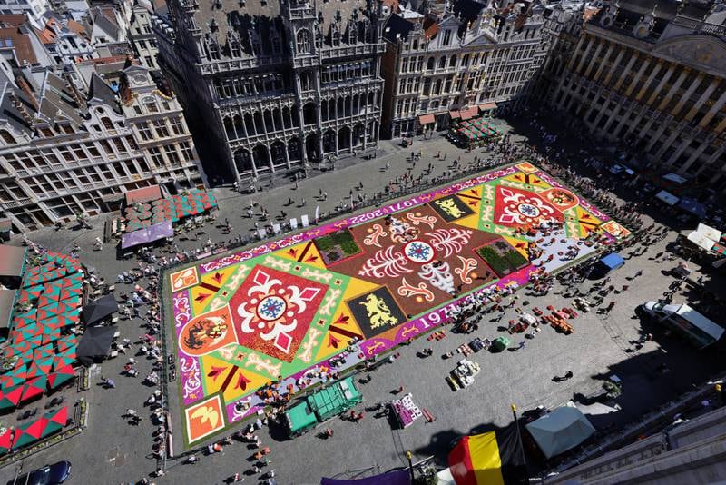 Volunteers arrange flowers to create a giant flower carpet, as part of celebrations to mark the event's 50th anniversary at Grand Place in Brussels, Belgium. The flower carpet is a nod to the very first creation in 1971, made from thousands of flowers and titled Arabesques. Getty Images