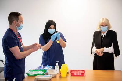 Camilla, Duchess of Cornwall, reacts as she helps staff to prepare a dose of a vaccine during a visit to a vaccination centre at Lordship Lane Primary Care Centre in London. Reuters
