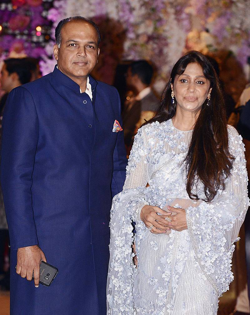 Indian Bollywood film director Ashutosh Gowariker poses for a picture with wife Sunita as they attend the pre-engagement party of India's richest man and Reliance Industries Limited Chairman, Mukesh Ambani’s eldest son Akash Ambani and fiancee Shloka Mehta, in Mumbai late on June 30, 2018. AFP