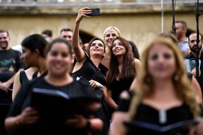 Choir singers take a selfie photos prior to a commemorative event in Beirut to honour the victims of the city's harbour explosion. EPA