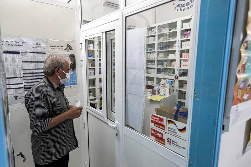 A man, mask-clad due to the COVID-19 coronavirus pandemic, waits to receive medication from the pharmacy of the Amel NGO in Lebanon's southern coastal city of Tyre on July 22, 2020. - Amid Lebanon's worst economic crisis since the 1975-1990 civil war, food aid has become a lifeline even for the once relatively affluent middle class. Lebanon's economy has collapsed in recent months, with the local currency plummeting against the dollar, businesses closing en masse and poverty soaring at the same alarming rate as unemployment. (Photo by JOSEPH EID / AFP)