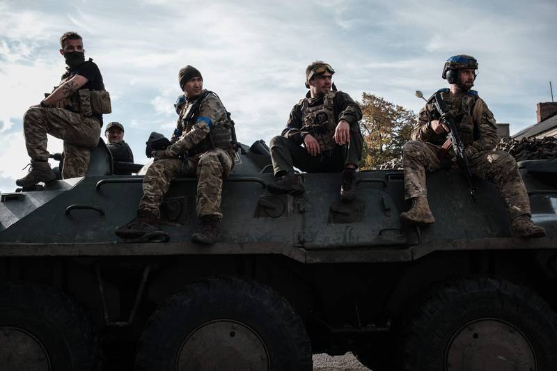 Ukrainian soliders rest on an armoured personnel carrier. AFP