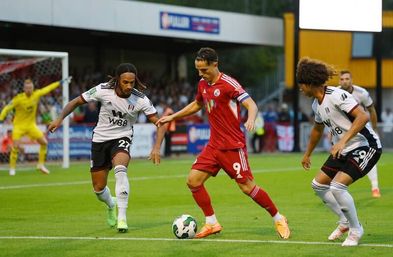 Tom Nichols of Crawley Town is put under pressure by Kevin Mbabu and Marlon Fossey of Fulham. Getty Images