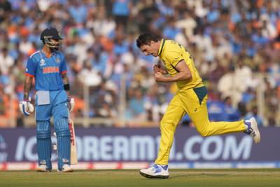 Australia's captain Pat Cummins celebrates after taking the wicket of India's Virat Kohli, left. AP 