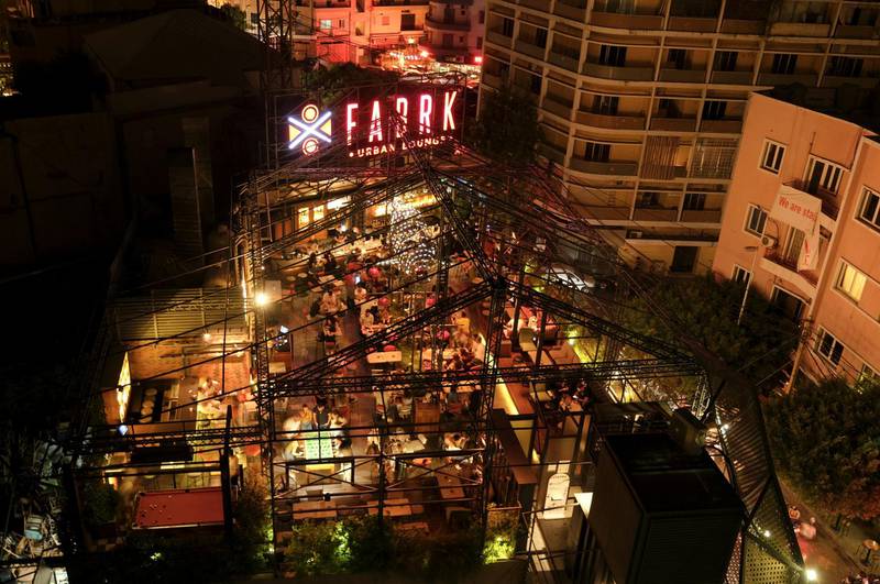 People in Beirut enjoy their evening at Fabrk rooftop in Mar Mikhael neighborhood, an area that was damaged in last year's port blast. Reuters