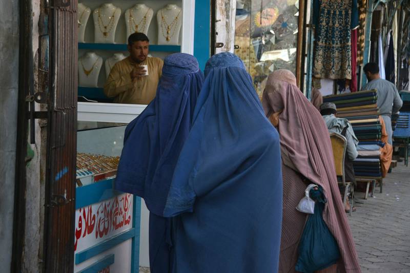 Afghan women walk in a Kandahar market. Even if Afghan girls can receive an education, the likelihood they will be able to put it to any use is low. AFP