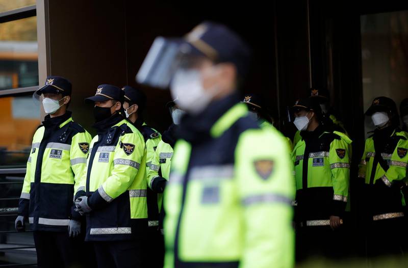 South Korean police officers wearing face masks as a precaution against the coronavirus, stand guard in Seoul, South Korea. AP Photo