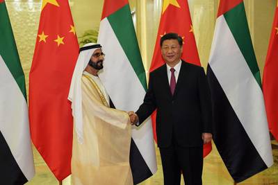 CORRECTION / United Arab Emirates Vice President and Prime Minister Sheikh Mohammed bin Rashid al Maktoum (L) shakes hands with President of the People's Republic of China Xi Jinping (R) as they meet at the Great Hall of People in Beijing on April 25, 2019. Leaders from 37 countries have been converging in Beijing for the Belt and Road Forum on April 25, hoping to grab a piece of the 1 trillion USD pie to improve their infrastructure.  / AFP / POOL / Andrea VERDELLI

