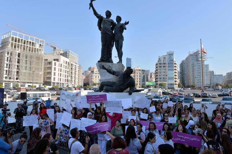 Protesters carry placards during a protest organized by the Lebanese Women Democratic Gathering  at Martyr's Square in downtown Beirut, Lebanon. EPA