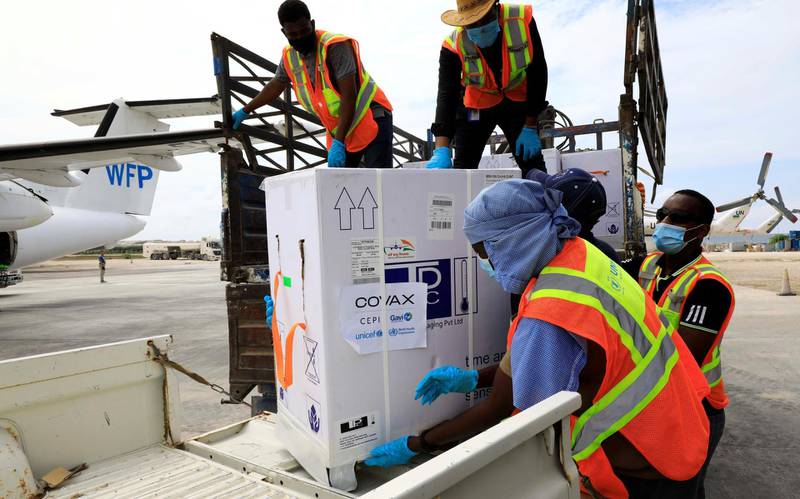 Oxford-AstraZeneca vaccines are unloaded by workers at Aden Adde International Airport in Mogadishu, Somalia. The doses are part of the international Covax scheme against the Covid-19 coronavirus. Reuters