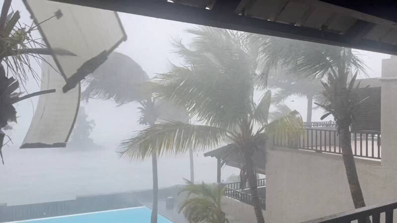 Sections of a building's roof fly off as the cyclone batters Trou-aux-Biches in Mauritius. Reuters
