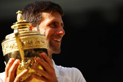 LONDON, ENGLAND - JULY 15:  Novak Djokovic of Serbia celebrates with the trophy after winning the Men's Singles final against Kevin Anderson of South Africa on day thirteen of the Wimbledon Lawn Tennis Championships at All England Lawn Tennis and Croquet Club on July 15, 2018 in London, England.  (Photo by Clive Brunskill/Getty Images)
