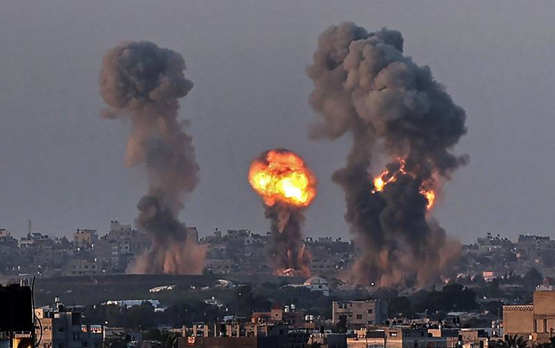 Smoke and a ball of fire rise above buildings in Khan Yunis in the southern Gaza Strip, during an Israeli air strike. AFP