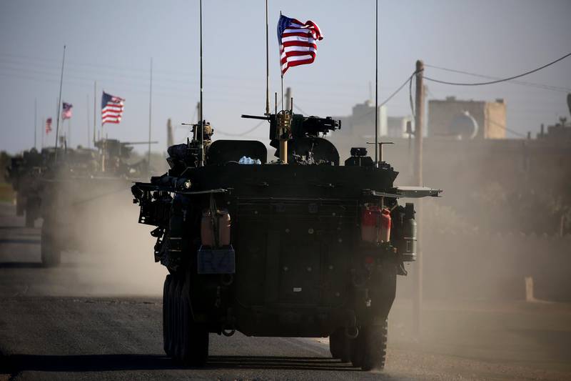 (FILES) In this file photo taken on March 05, 2017 A convoy of US forces armoured vehicles drives near the village of Yalanli, on the western outskirts of the northern Syrian city of Manbij. The United States is preparing to withdraw its troops from Syria, US media reported on December 19, 2018, a major move that throws into question America's role in the region.
 / AFP / DELIL SOULEIMAN
