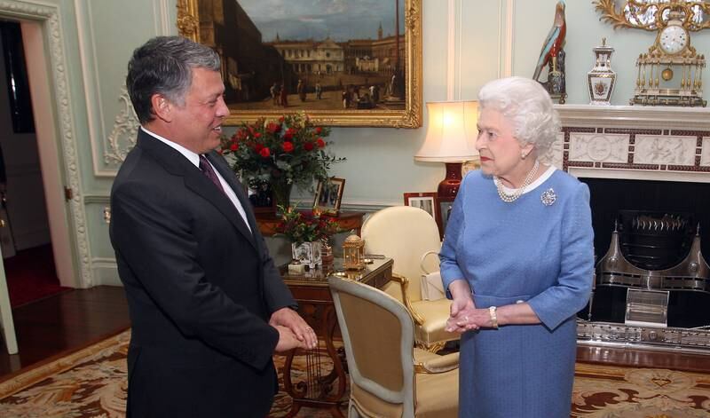 Queen Elizabeth II greets King Abdullah II of Jordan at her Buckingham Palace residence in London. Getty