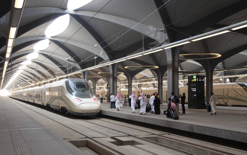 Saudi passengers walk in the platform at Mecca's train station on October 11, 2018 as the new high-speed railway line linking Mecca and Medina opens. The Haramain High Speed Rail system will transport Muslim pilgrims, as well as regular travellers, 450 kilometres (280 miles) between the two cities via the Red Sea port of Jeddah in two hours. Thirty-five passenger trains capable of travelling at speeds of 300 kilometres per hour will slash the travel time from several hours to 120 minutes, transport officials said. The rail project, dogged by several delays, was built at a cost of more than $16 billion, according to Saudi media.
 / AFP / BANDAR ALDANDANI
