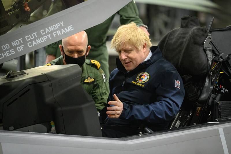 Mr Johnson sits in the cockpit of an Lockheed Martin F-35 Lightning II during a visit to the 'HMS Queen Elizabeth' aircraft carrier on May 21. The ship was about to depart for Asia on its first operational deployment.