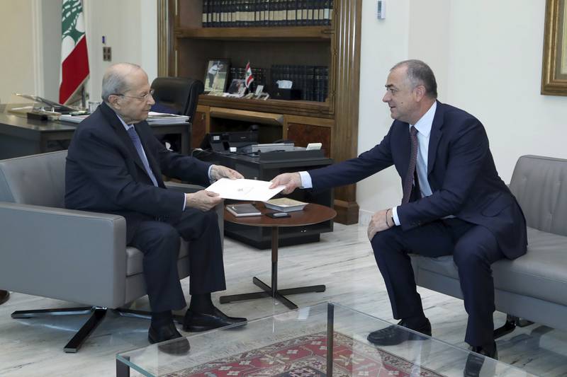 Mr Aoun, left, receives the final draft of the maritime border agreement with Israel. AP
