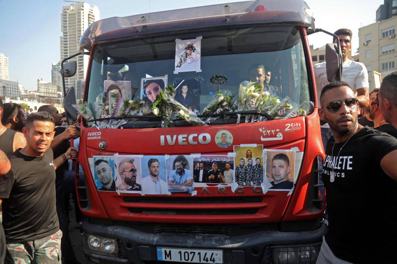 A fire engine carrying portraits of blast victims is driven during a remembrance ceremony at the port of Lebanon’s capital.