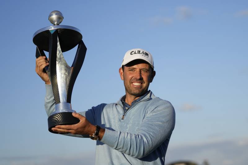 Charles Schwartzel of South Africa holds up the trophy after winning the inaugural LIV Golf Invitational at the Centurion Club in St Albans, England. AP Photo