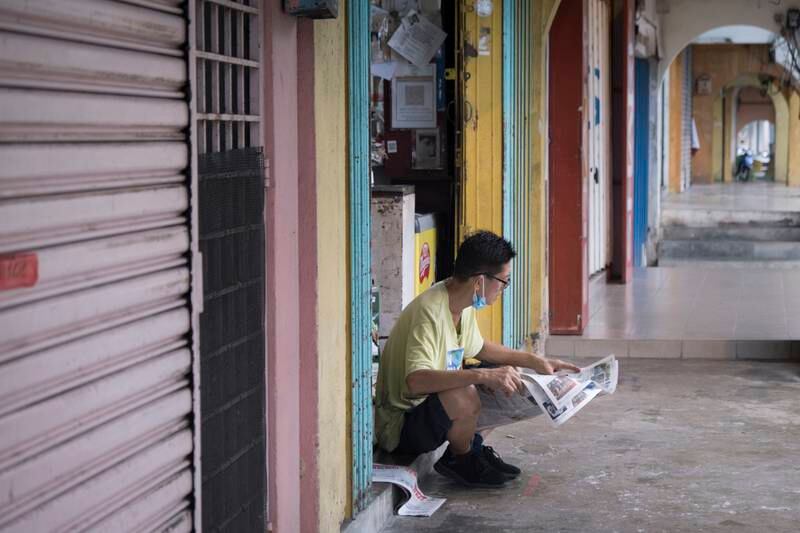 A man catches up with the news in Kuala Lipis