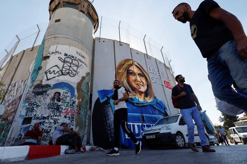 Palestinians walk in front of a mural depicting killed Palestinian-American journalist Shireen Abu Akleh in Bethlehem in the Israeli-occupied West Bank. Reuters