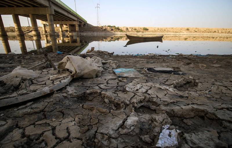 A picture taken on March 20, 2018 shows a view of the dried-up shore of an irrigation canal near the village of Sayyed Dakhil, to the east of Nasariyah city some 300 kilometres (180 miles) south of Baghdad.
Farmers in Sayyed Dakhil have traditionally lived off their land where there used to be no need for wells, but a creeping drought is now threatening agriculture and livelihoods in the area.
Weather patterns are largely to blame for the crisis, but while rain accounts for 30 percent of Iraq's water resources, the remaining 70 percent is drawn from rivers and marshes shared with Iran, Turkey and Syria, which has played a part in Iraq's drought. / AFP PHOTO / HAIDAR MOHAMMED ALI