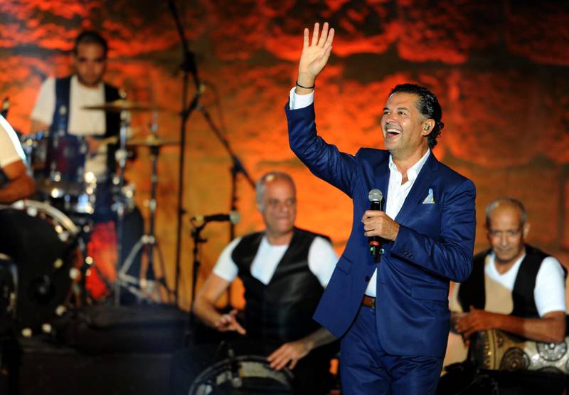 Lebanese singer Ragheb Alama performs during the 53rd session of the International Festival of Carthage at the Roman Theatre of Carthage on July 19, 2017 in Tunis. (Photo by SALAH HABIBI / AFP)