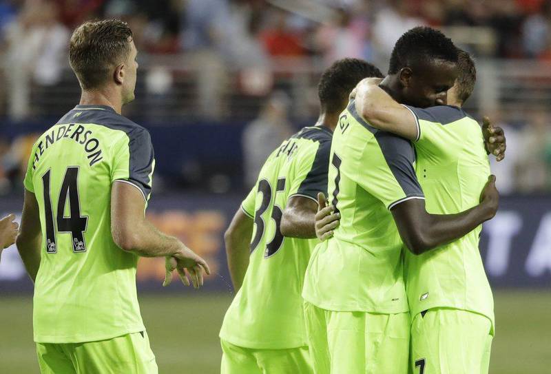 Liverpool’s Divock Origi, centre, is hugged by teammate James Milner, right, after Origi’s goal against AC Milan during the second half of an International Champions Cup match Saturday, July 30, 2016, in Santa Clara, California. Marcio Jose Sanchez / AP Photo