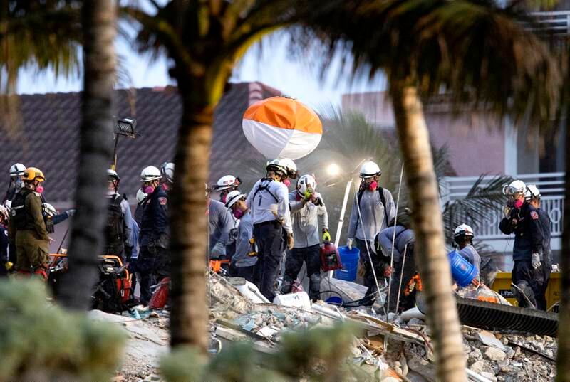 Rescue personnel sift through rubble for survivors at Champlain Towers South in Surfside, Florida. Part of the apartment block collapsed and most of its occupants remain missing. AP
