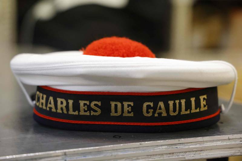 A French navy beret bears the ship's name  