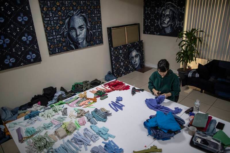 The artist separates fabric waste to use as materials for her artworks.