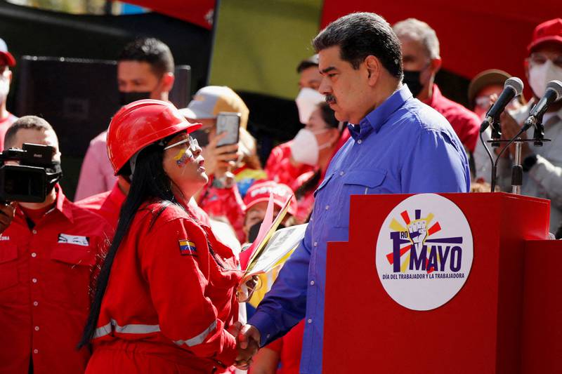 Venezuela's President Nicolas Maduro shakes hands with a state oil company PDVSA worker during May Day celebrations in Caracas. Reuters