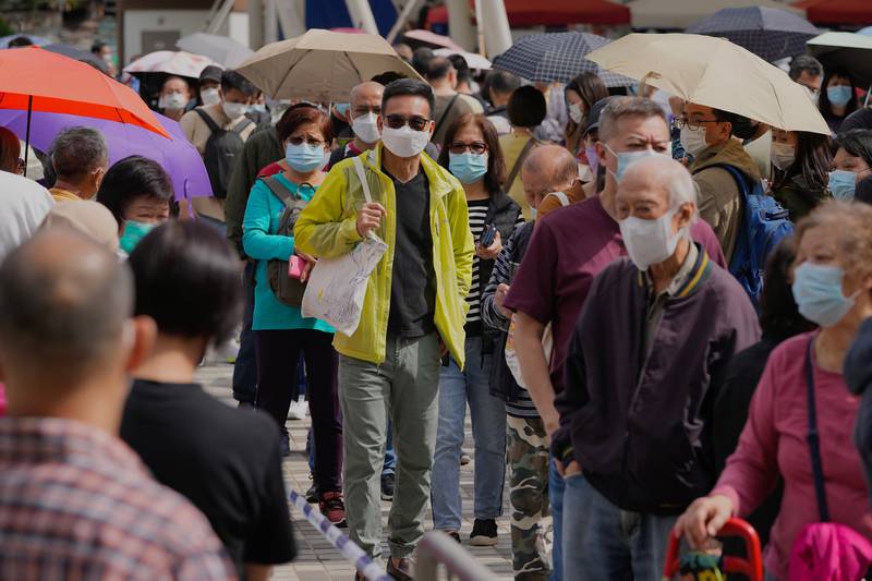 Residents queue for PCR tests at a housing estate in Hong Kong as the territory battles a wave of Covid-19 cases. AP