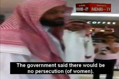 A frame grab from a video posted on YouTube shows a member of Saudi Arabian Commission for the Promotion of Virtue and Prevention of Vices arguing with a young woman after ordering her to leave a shopping mall in Saudi Arabia. The caption on the video is a translation of the woman speaking to the men.