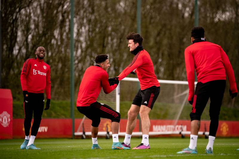 Jadon Sancho and Harry Maguire wrestle in training. 