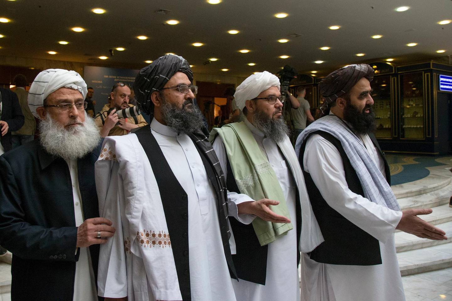 FILE - In this May 28, 2019 file photo, Mullah Abdul Ghani Baradar, the Taliban group's top political leader, second left, arrives with other members of the Taliban delegation for talks in Moscow, Russia. Afghanistanâ€™s Taliban leaders agreed they wanted a deal with the United States, but some among them were in more of a hurry than others. Even before U.S. President Donald Trump cancelled a mysterious Camp David summit on Saturday, Sept. 7, 2019, the Taliban negotiators were at odds with the council of leaders, or shura, that rules the Islamic movement. (AP Photo/Alexander Zemlianichenko, File)