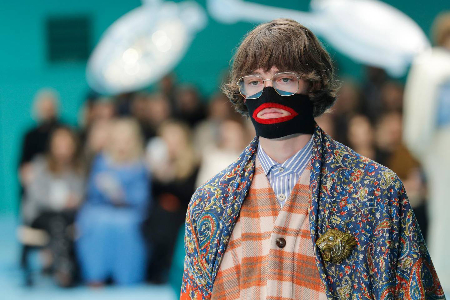 FILE - In this Feb. 21, 2018, file photo, a model wears a creation as part of the Gucci women's Fall/Winter 2018-2019 collection, presented during the Milan Fashion Week, in Milan, Italy. Italian fashion designer Gucci is announcing a major push to step up its diversity hiring following an uproar over an $890 sweater that resembled blackface, Friday, Feb. 15, 2019. The company also says it will hire a global director for diversity and inclusion, a newly created role. Gucci also is promising to launch a scholarship program to cultivate diverse design talent.  (AP Photo/Antonio Calanni, File)