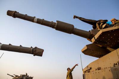 Israeli soldiers work on tanks in the Israeli-controlled Golan Heights near the border with Syria and Lebanon. AP Photo
