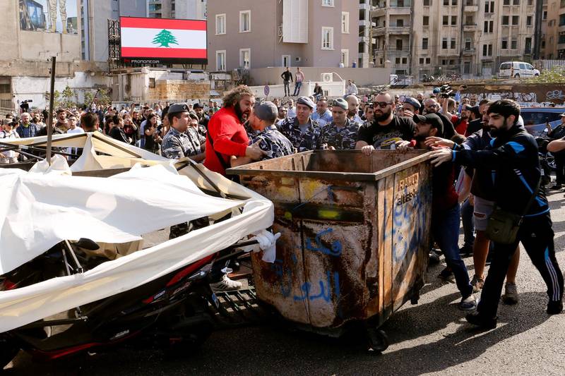 Police intervene after supporters of the Lebanese Shiite groups Hezbollah and Amal fought with protesters at a roadblock on a main road in Beirut. Reuters