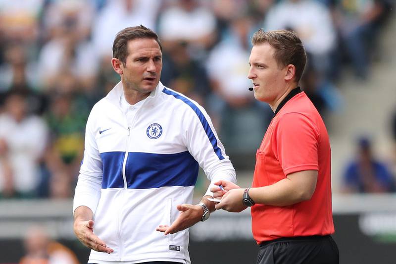 Frank Lampard, manager of Chelsea, talks to the fourth official.