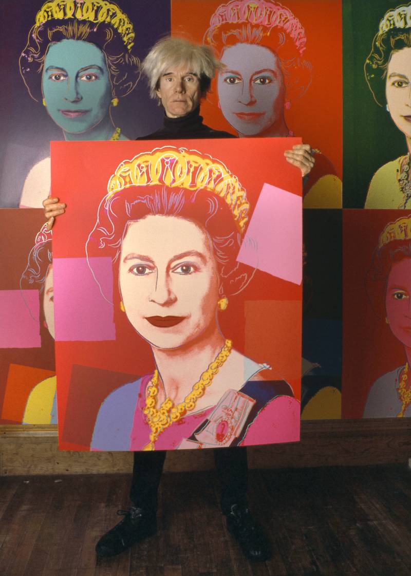 Ai-Da may be the first robot to create a portrait of the monarch, but she certainly isn't the first artist. Here American Pop artist Andy Warhol holds a silkscreen print of Queen Elizabeth in his studio, the Factory, in New York, 1985. Getty Images