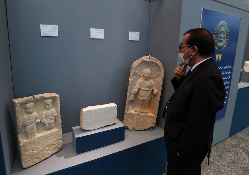 A visitor looks at ancient artefacts.