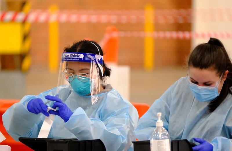 Health workers at work in a drive-through coronavirus testing centre in Melbourne, Victoria state, Australia. Reuters