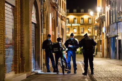 Members of the French National police, CRS, speak to a delivery man, as they patrol in the streets of Toulouse. AFP